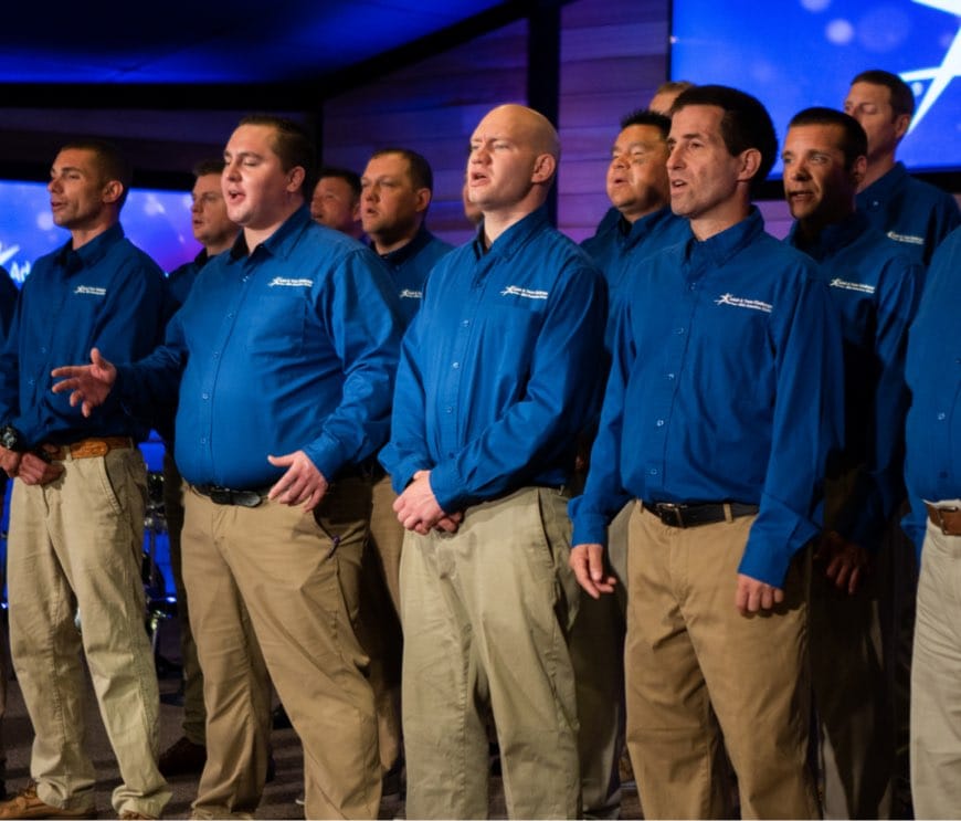 group of men singing in choir