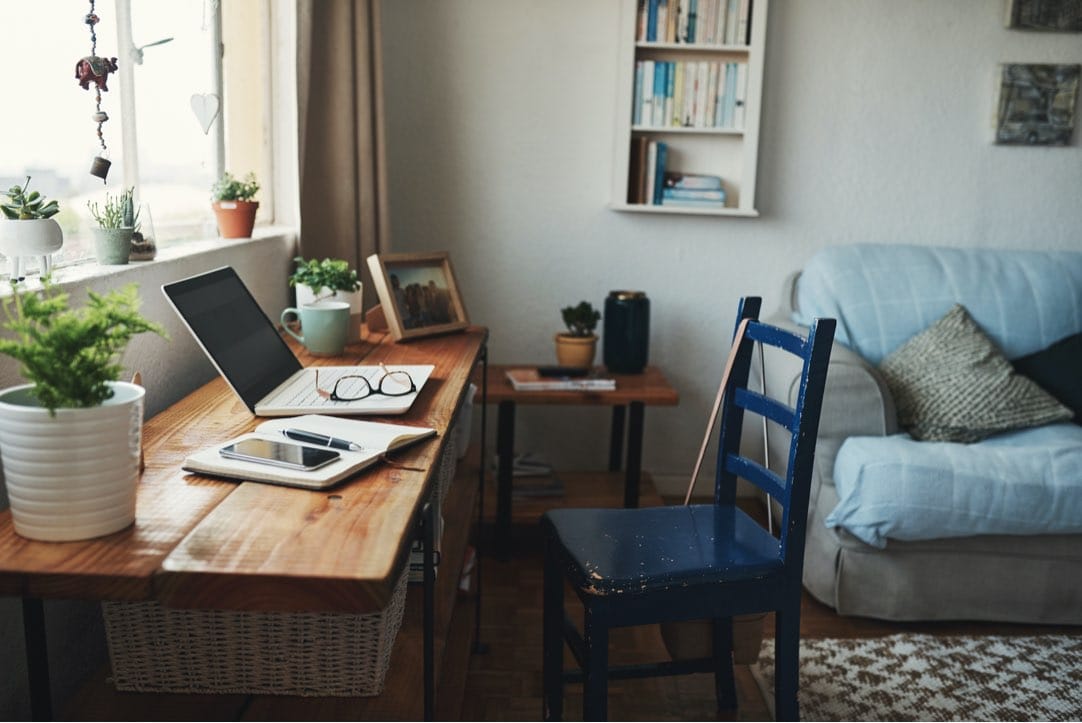 technology and a notebook on a desk in an empty home office