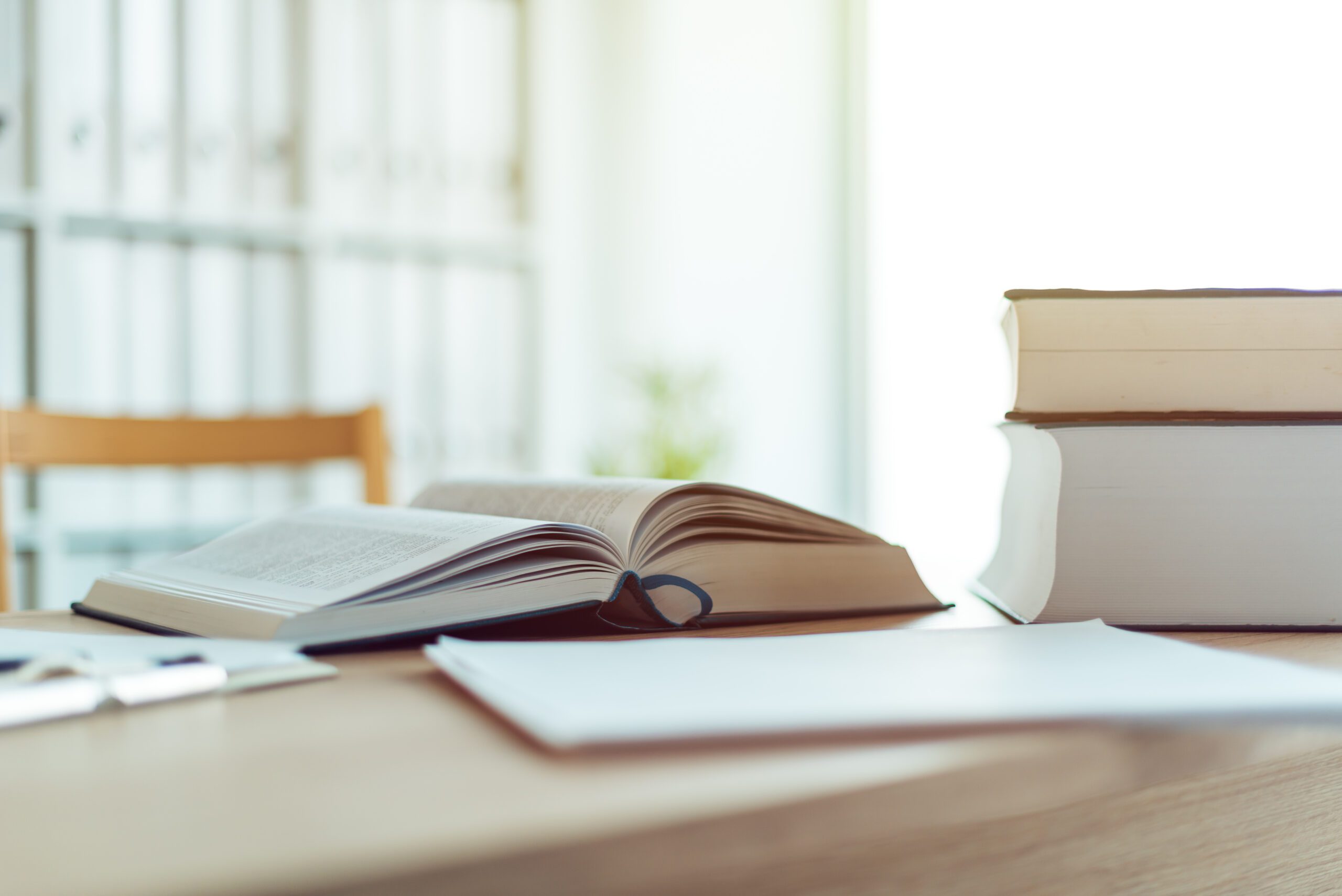 Open book on desk in law firm office, selective focus